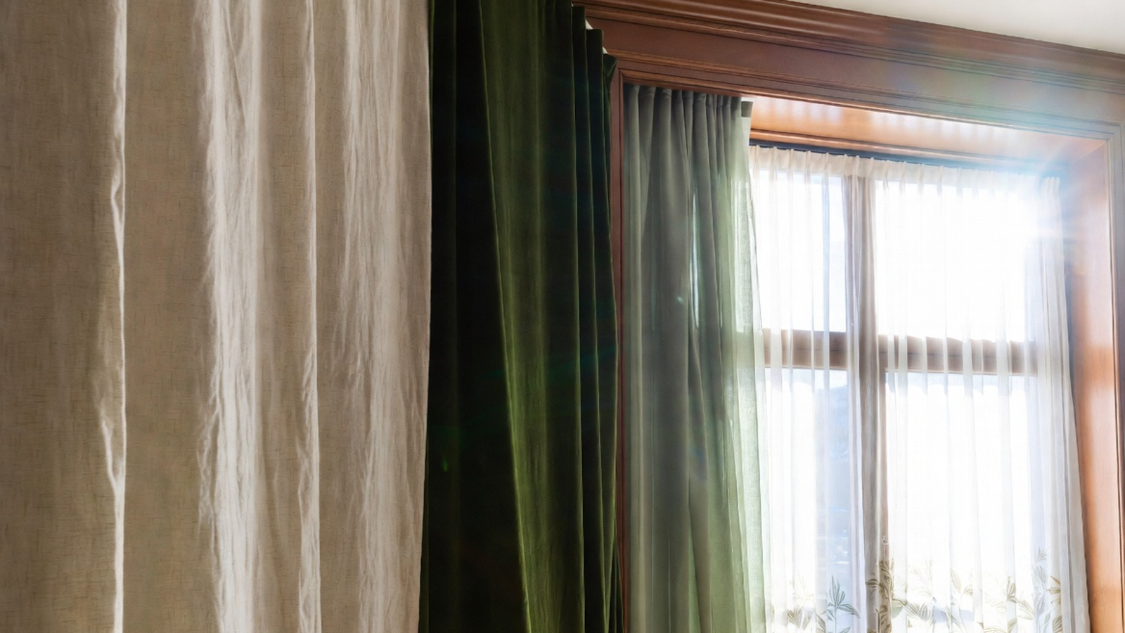 Linen, velvet, and sheer curtains displayed in one bright home setting to compare texture, fullness, and light filtering