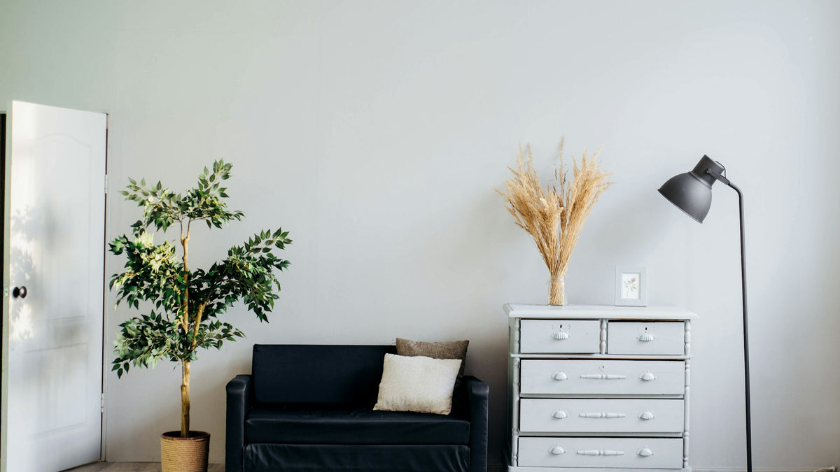 Warm golden light filtering through heavy textured linen curtains in a cozy living room 16:9