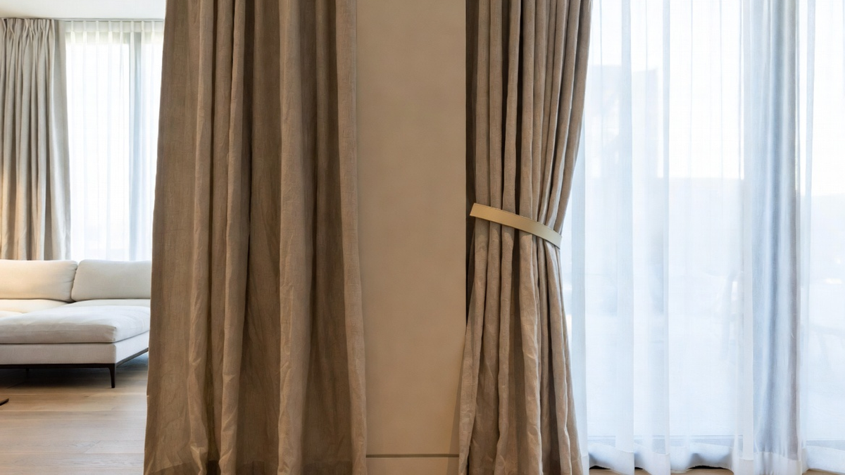 Magnetic tiebacks holding back modern curtains neatly in a clean minimalist interior