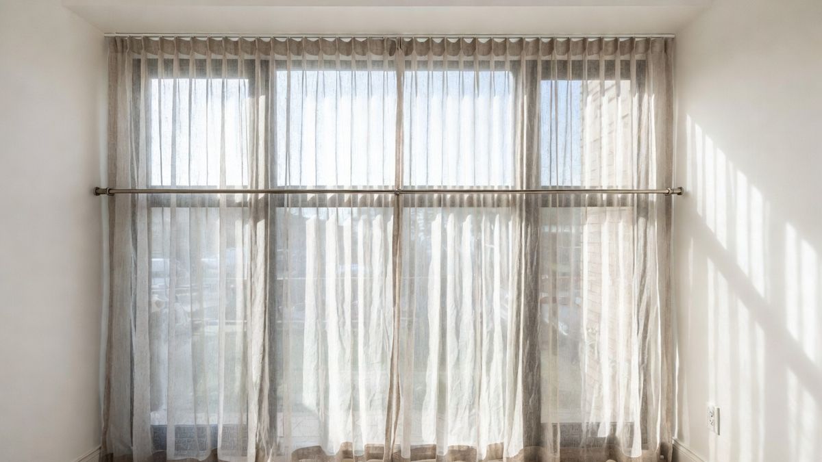 Cafe curtains mounted at a balanced height in a bright kitchen window with privacy and daylight